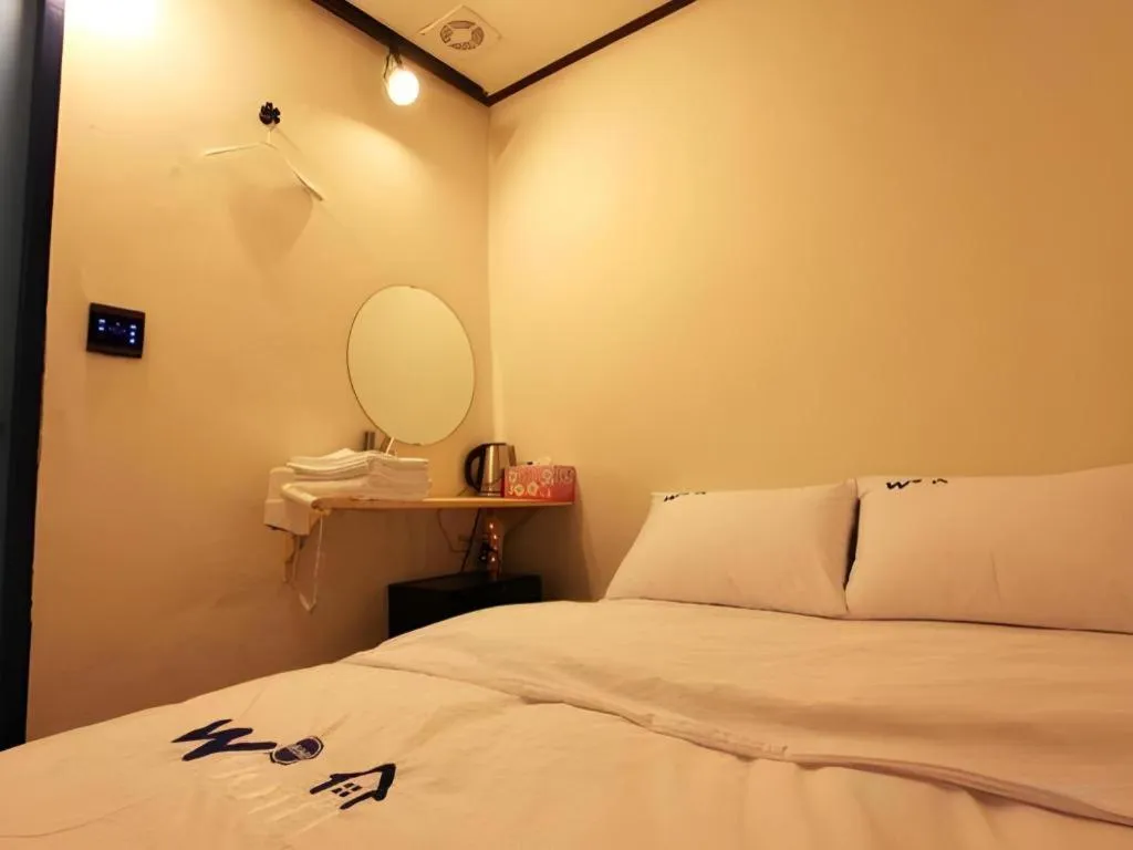 Bed in W Mini Hotel