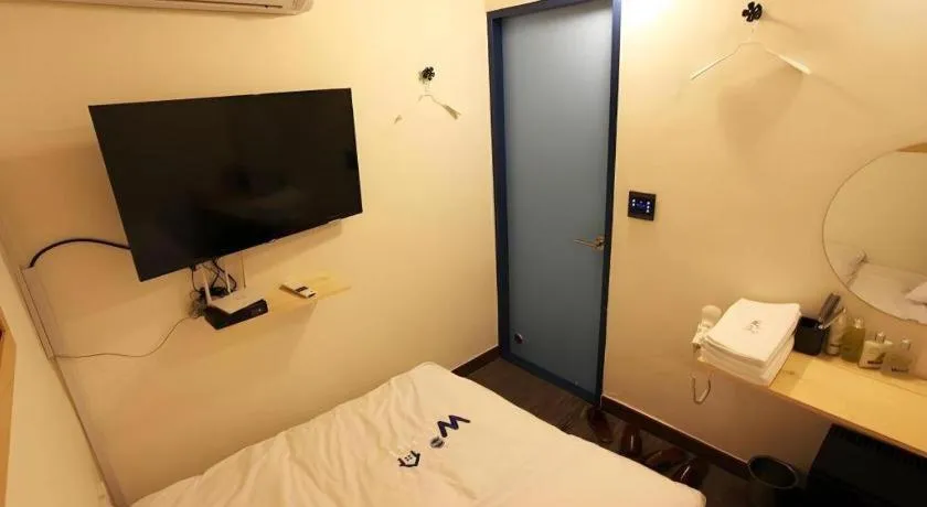 Bed in W Mini Hotel