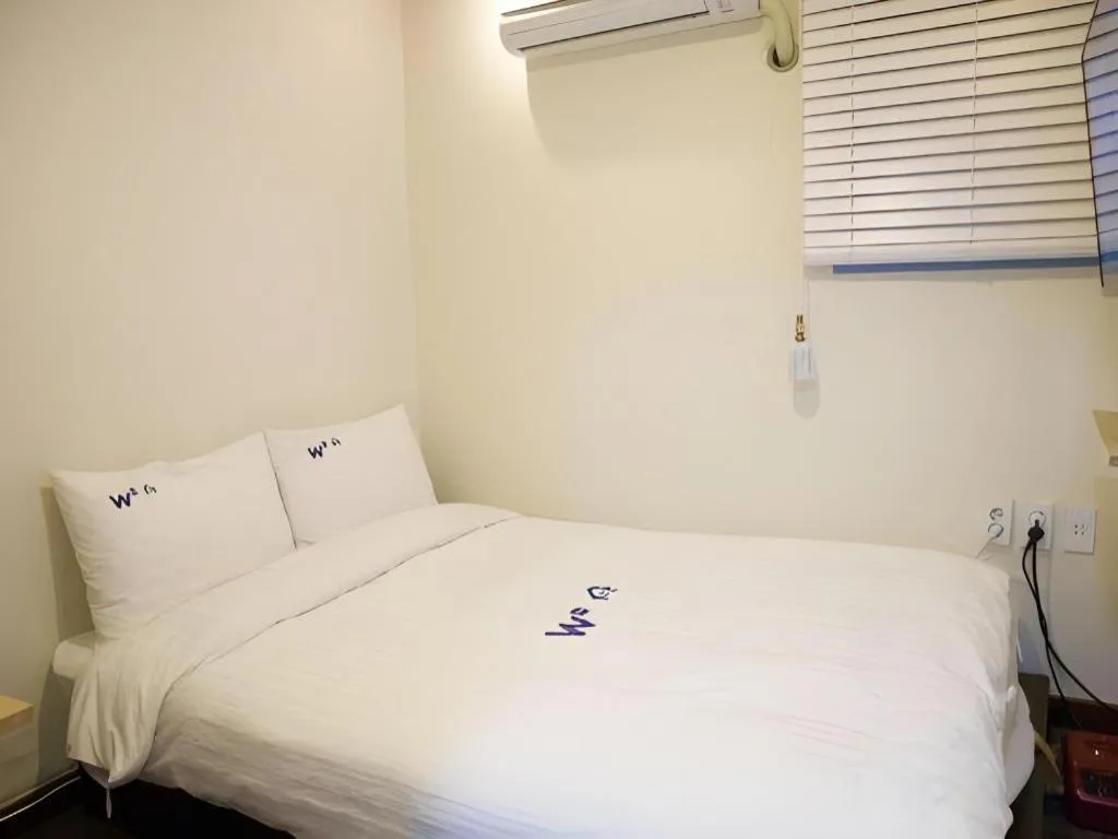 Bed in W Mini Hotel
