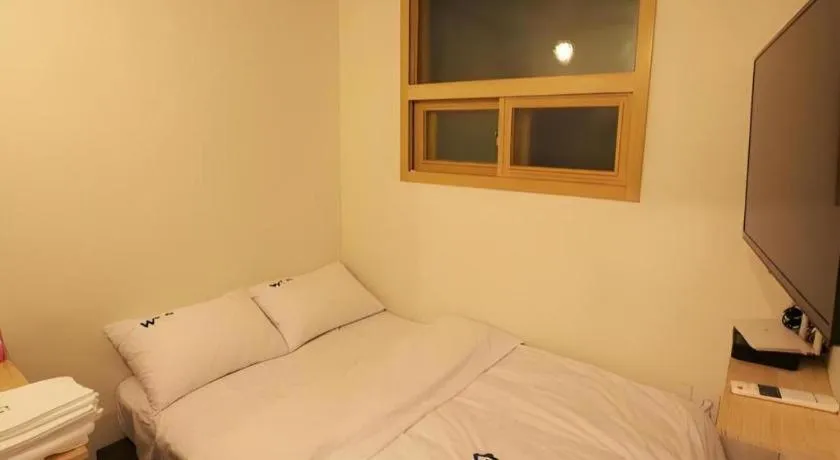 Bed in W Mini Hotel