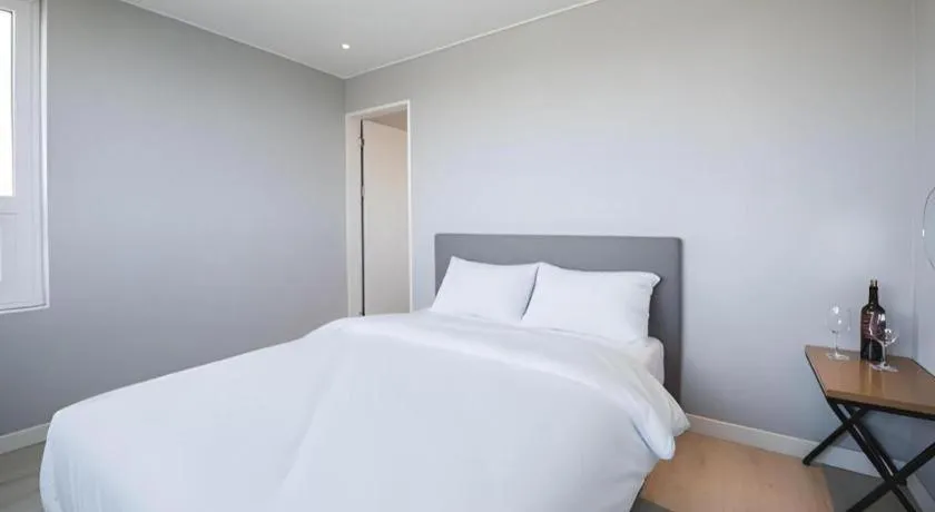 Bed in Sallys Jeju Hotel