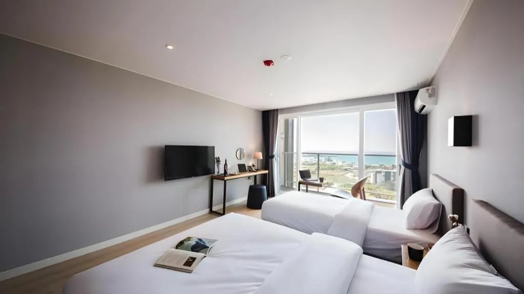 Bed in Sallys Jeju Hotel