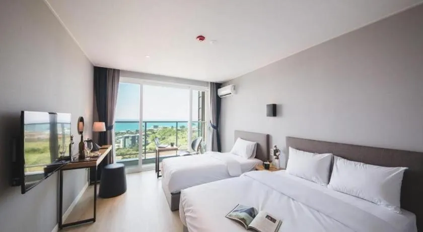 Bed in Sallys Jeju Hotel