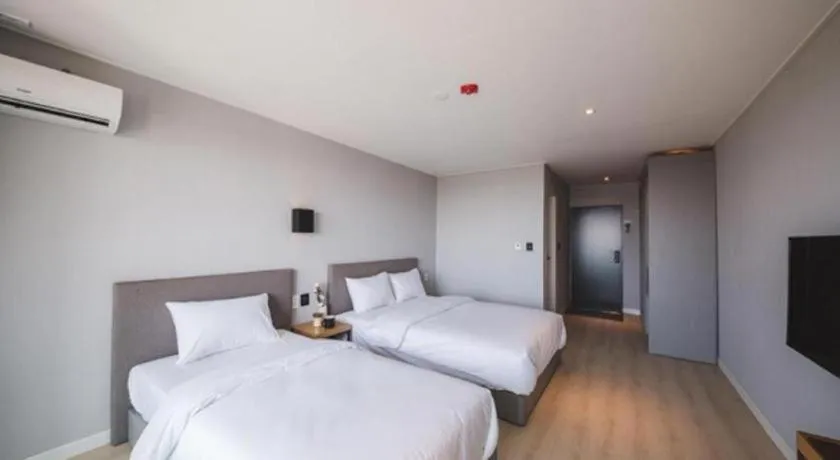 Bed in Sallys Jeju Hotel