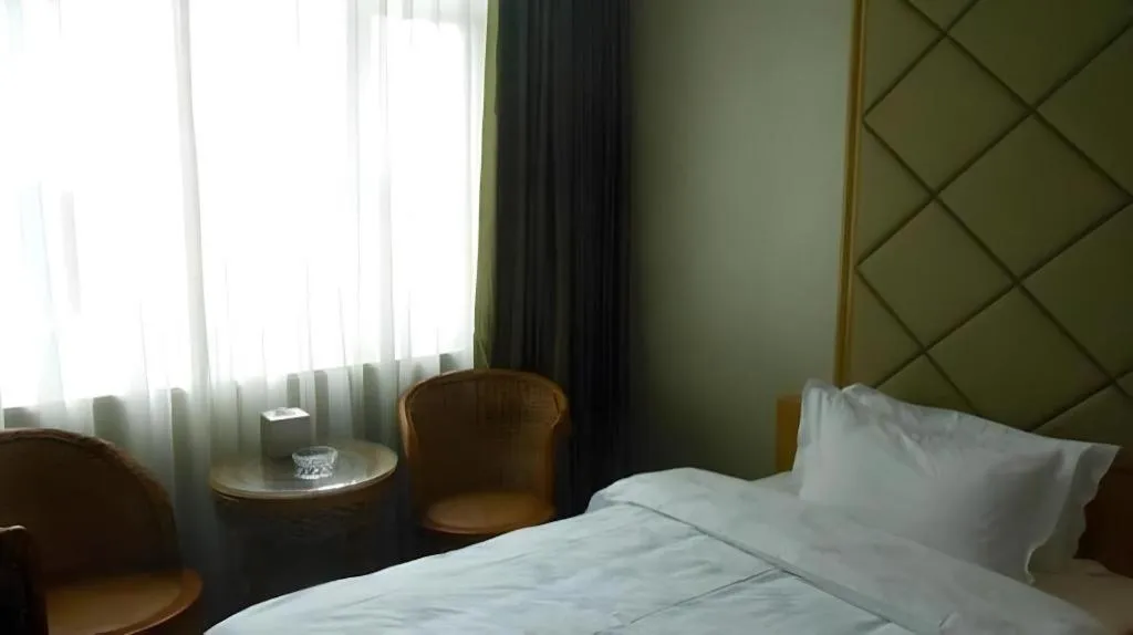 Bed in San Jiang Grand Hotel