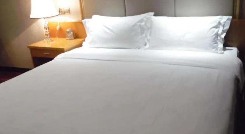 Bed in San Jiang Grand Hotel