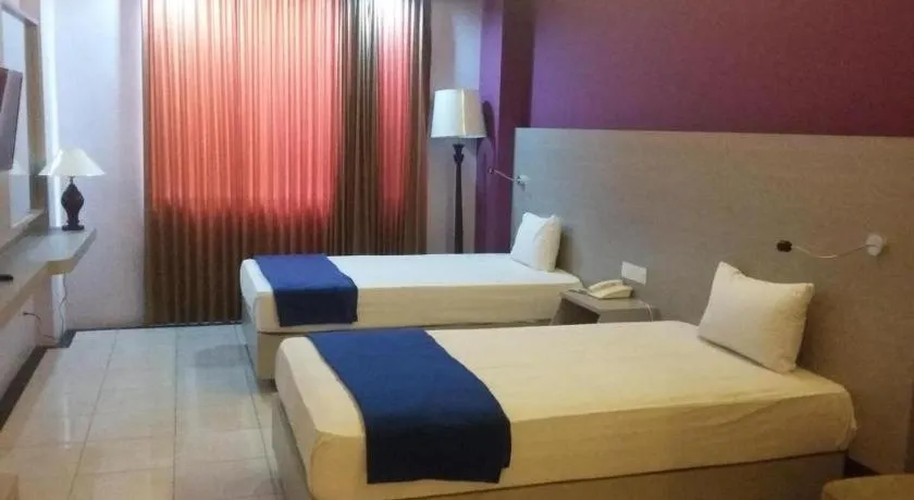 Bed in Kharisma Hotel