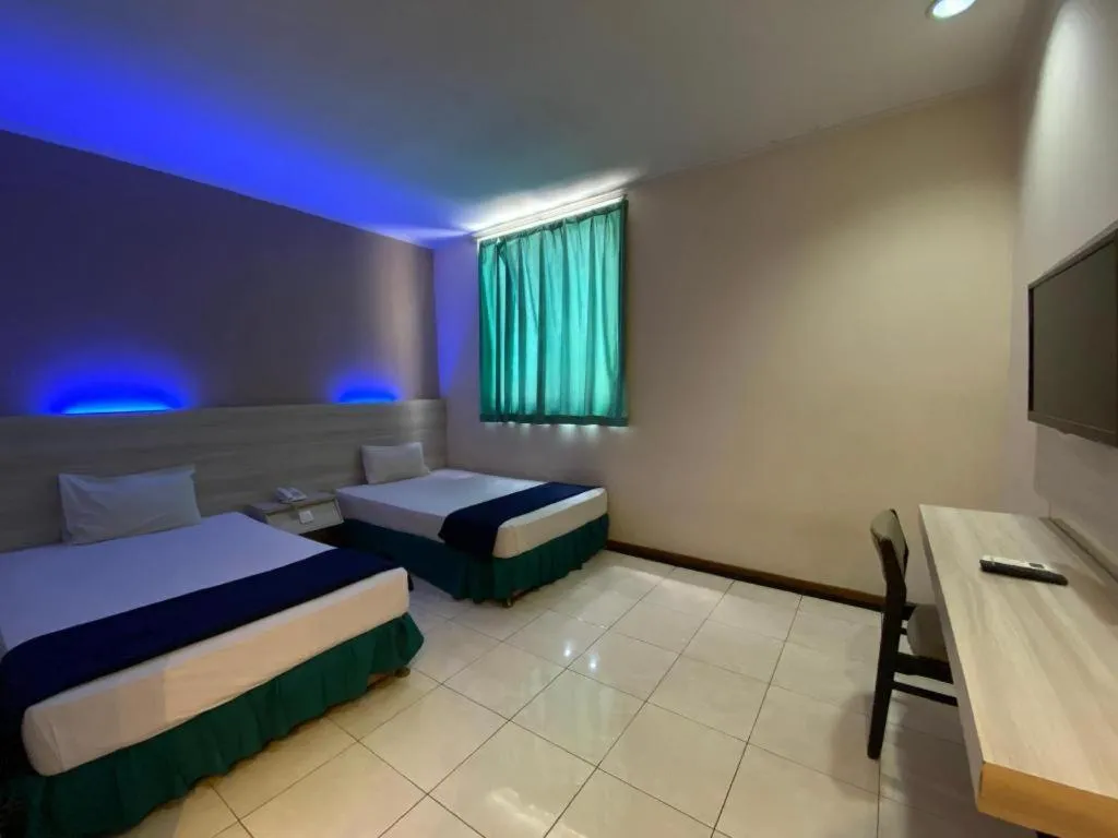 Bed in Kharisma Hotel