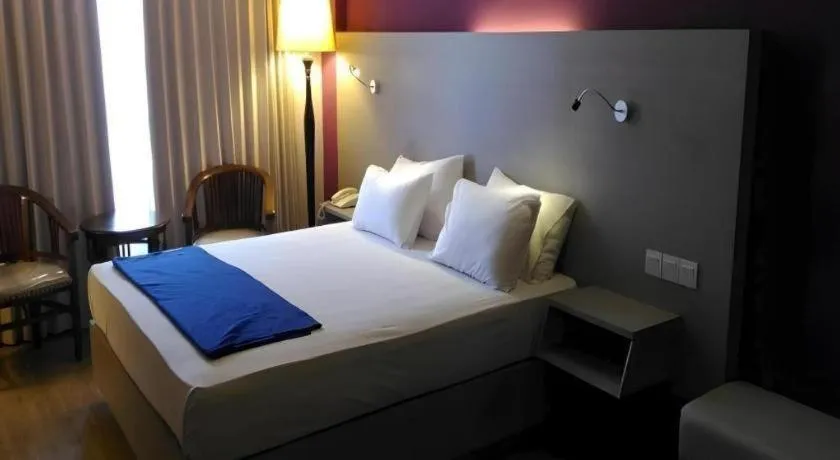 Bed in Kharisma Hotel