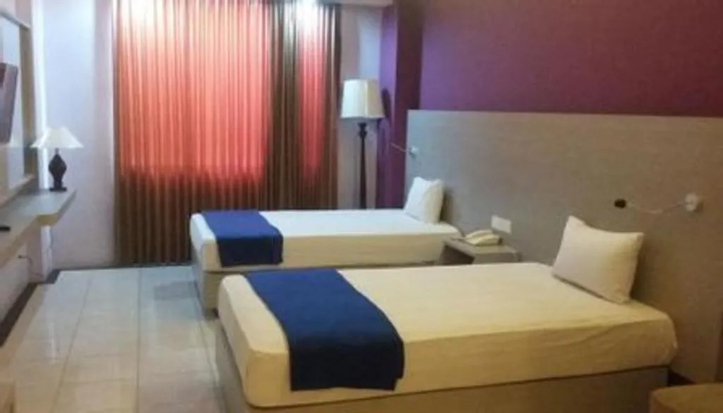 Bed in Kharisma Hotel