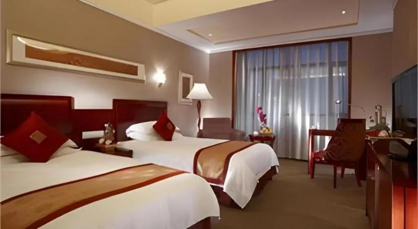 Bed in New Century Pujiang Hotel