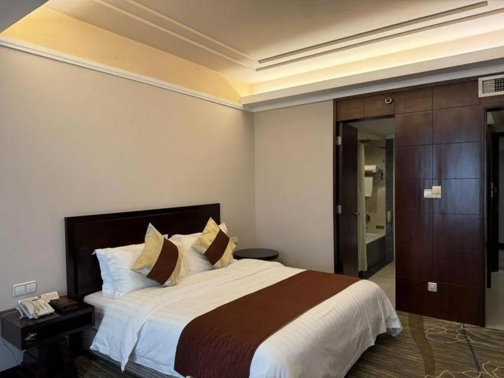 Bed in New Century Pujiang Hotel