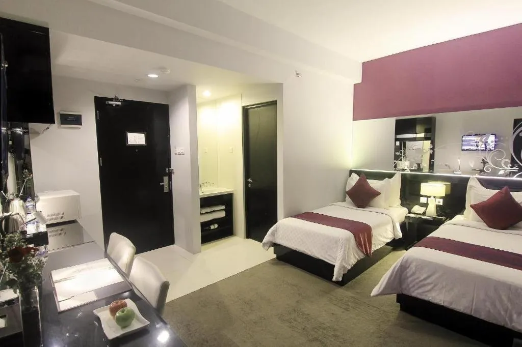 Bed in Grand Darmo Suite by AMITHYA