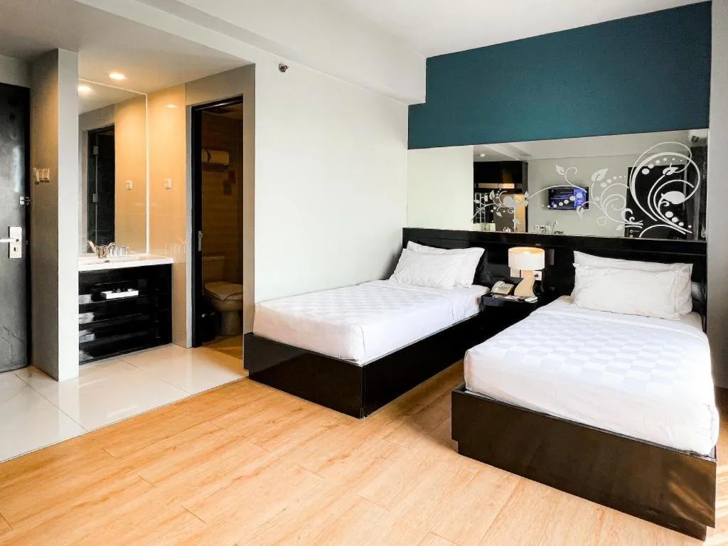 Bed in Grand Darmo Suite by AMITHYA