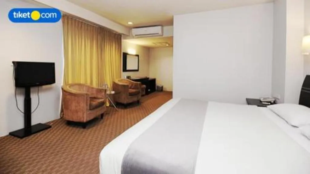 Bed in Kenari Tower Hotel