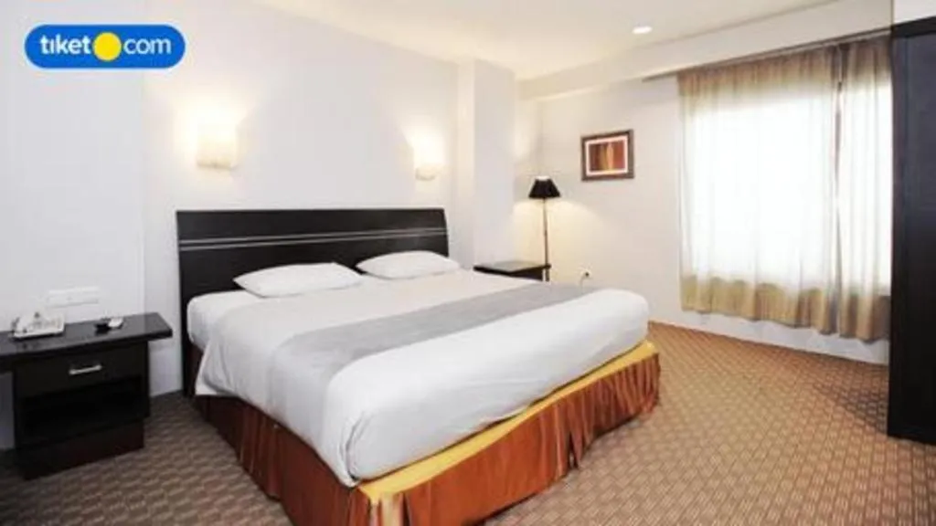 Bed in Kenari Tower Hotel