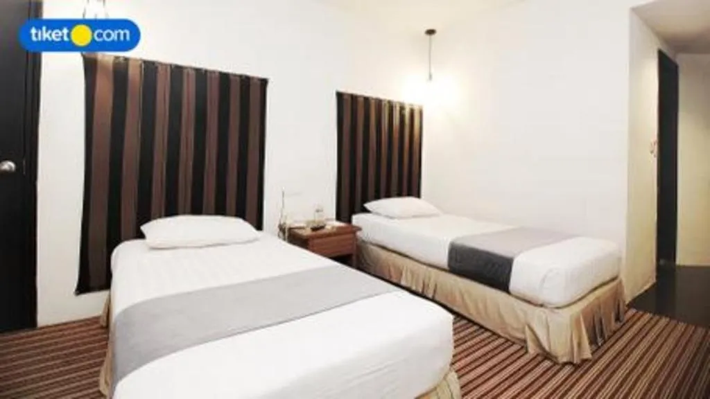 Bed in Kenari Tower Hotel