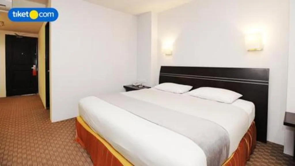 Bed in Kenari Tower Hotel