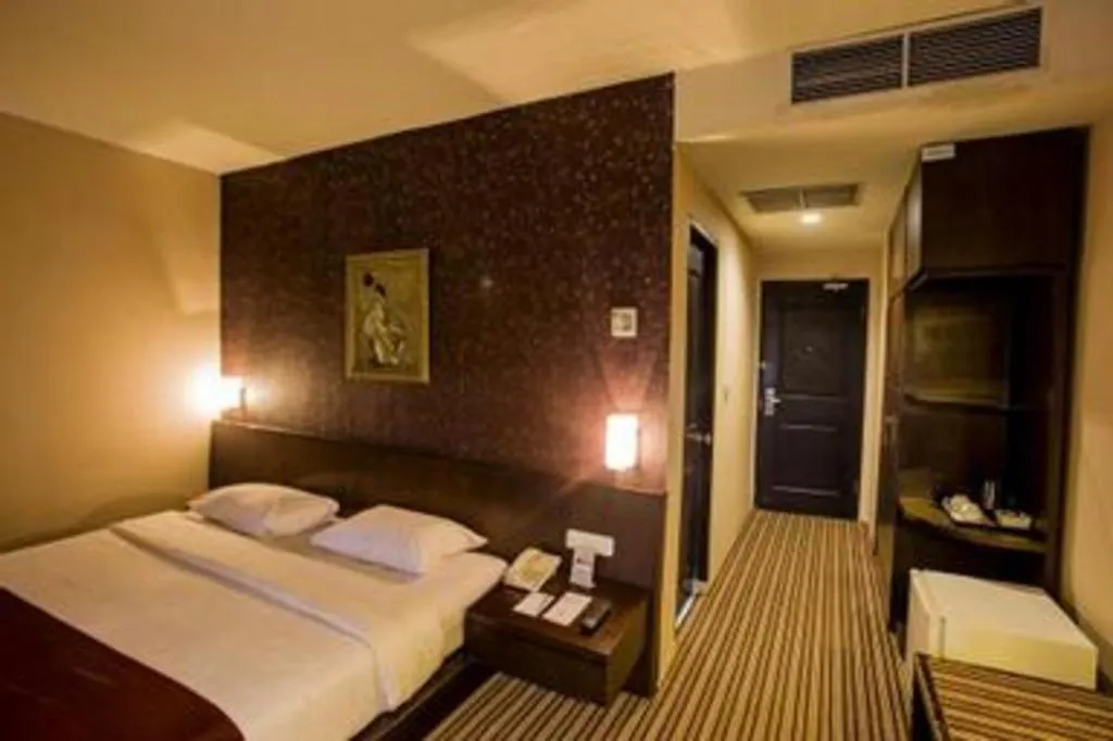 Bed in Kenari Tower Hotel