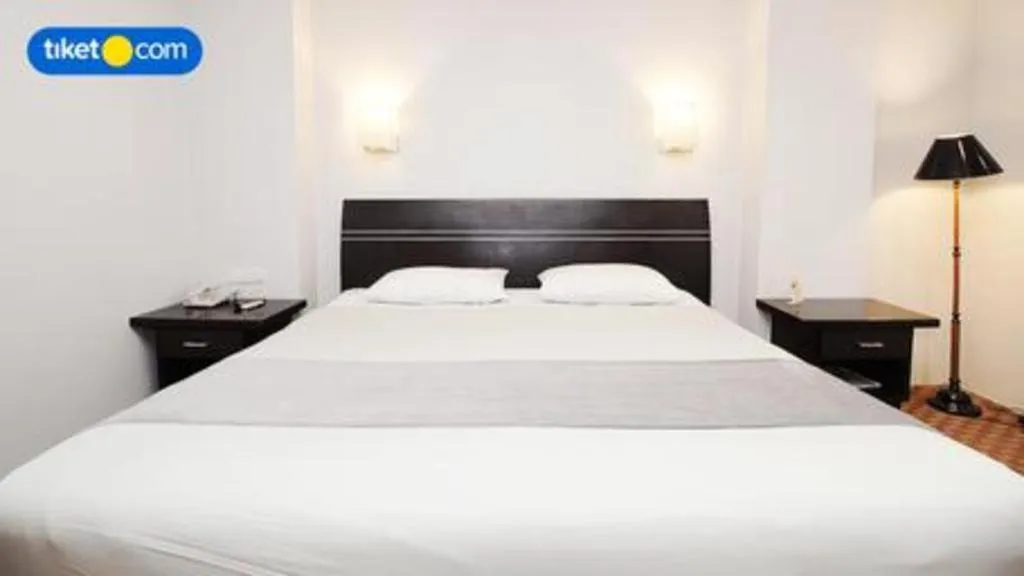 Bed in Kenari Tower Hotel