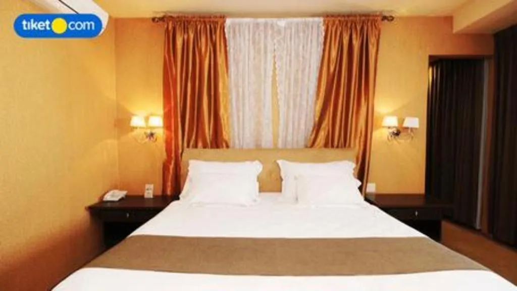 Bed in Kenari Tower Hotel