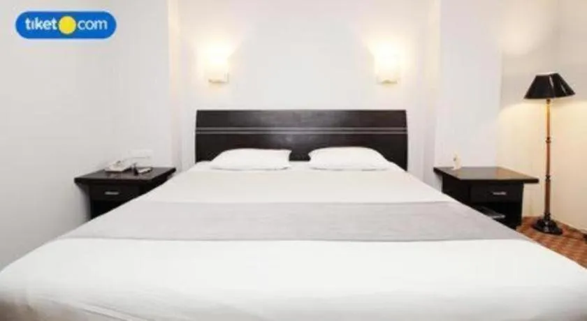 Bed in Kenari Tower Hotel