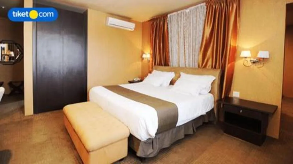 Bed in Kenari Tower Hotel