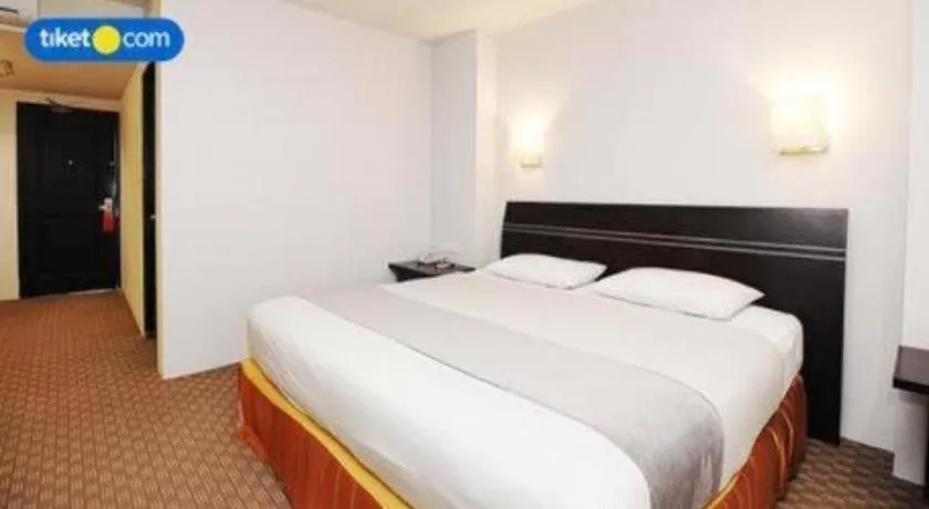 Bed in Kenari Tower Hotel