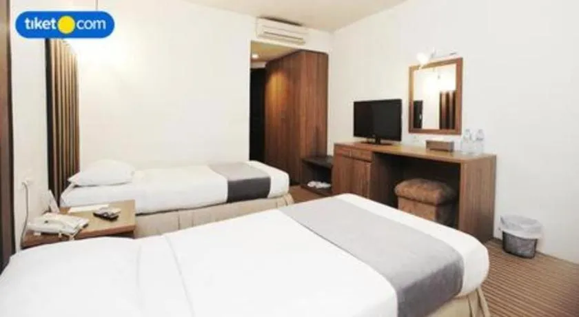 Bed in Kenari Tower Hotel