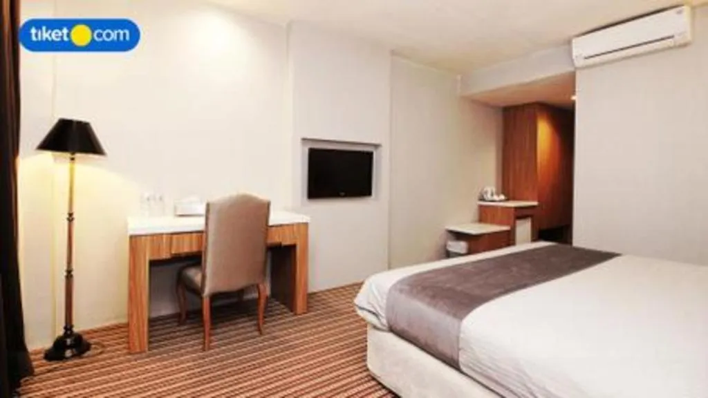 Bed in Kenari Tower Hotel