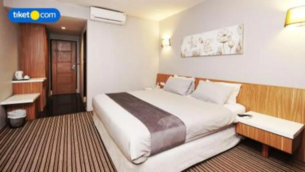 Bed in Kenari Tower Hotel