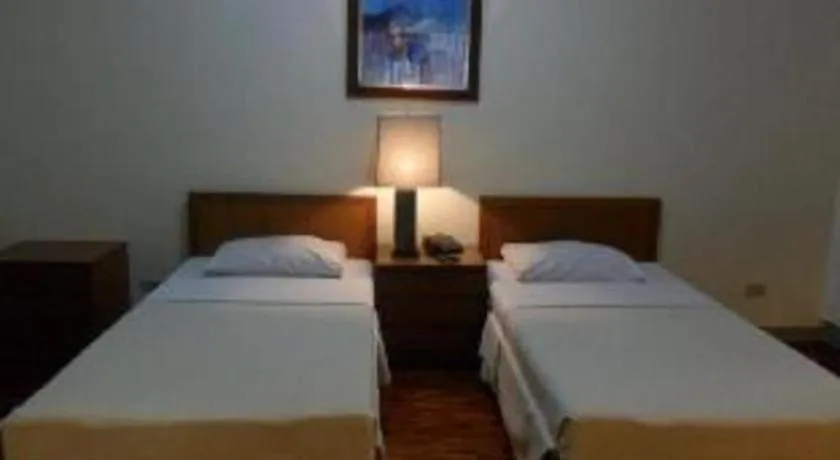 Bed in Amorsolo Mansion Hotel