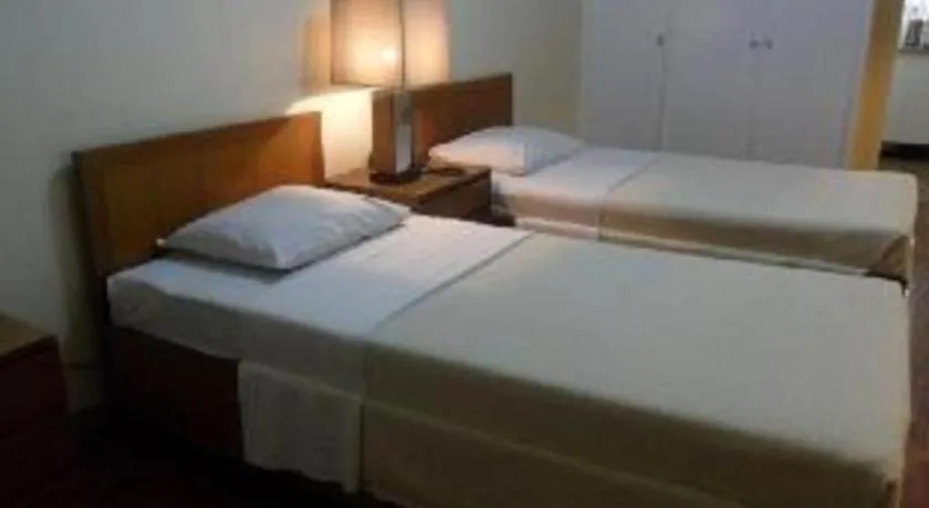 Bed in Amorsolo Mansion Hotel