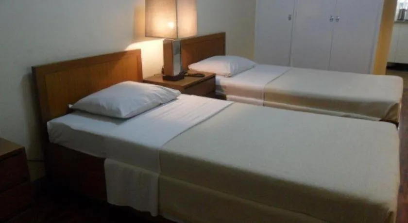 Bed in Amorsolo Mansion Hotel