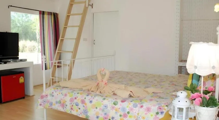 Bed in Rak Na Suan Pueng Resort