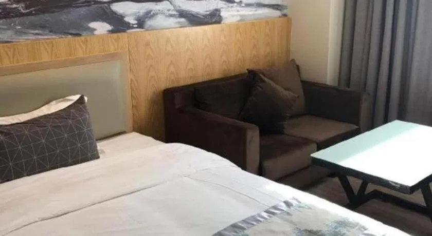 Bed in ST. MORITZ BUSINESS HOTEL