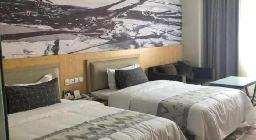 Bed in ST. MORITZ BUSINESS HOTEL