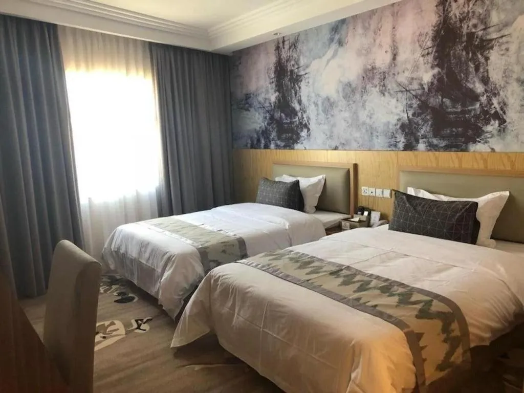 Bed in ST. MORITZ BUSINESS HOTEL