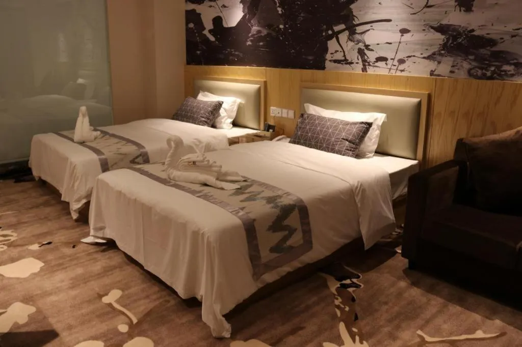 Bed in ST. MORITZ BUSINESS HOTEL