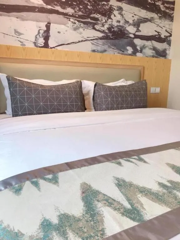 Bed in ST. MORITZ BUSINESS HOTEL