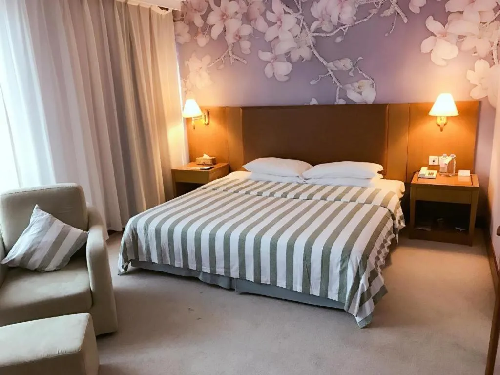 Bed in Culture Plaza Hotel