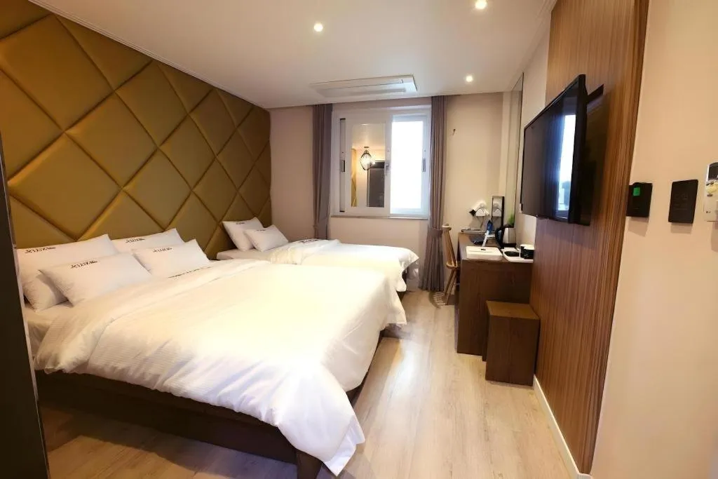 Bed in Jeju Lux Hotel