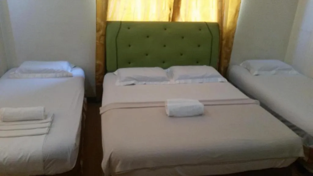 Bed in Rich Manor Pension House