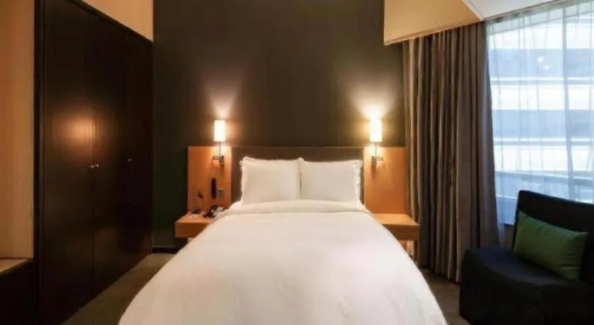 Bed in Beijing New World Center Tongpai Hotel