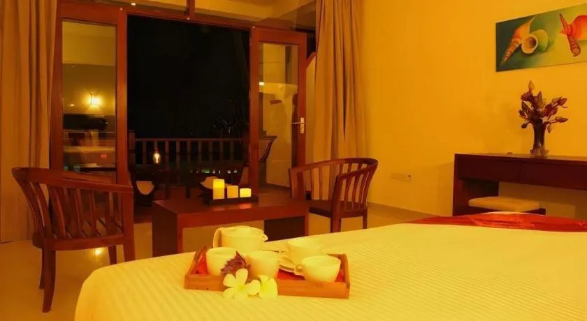 Bed in Whispering Palms Hotel