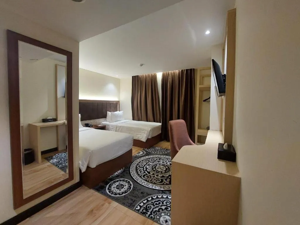 Bed in Grand Qin Hotel Syariah