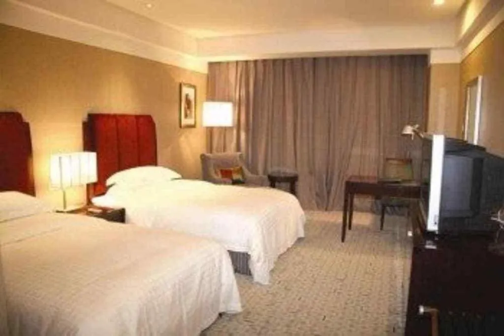 Bed in Grand New Century Hotel Binhai Tianjin