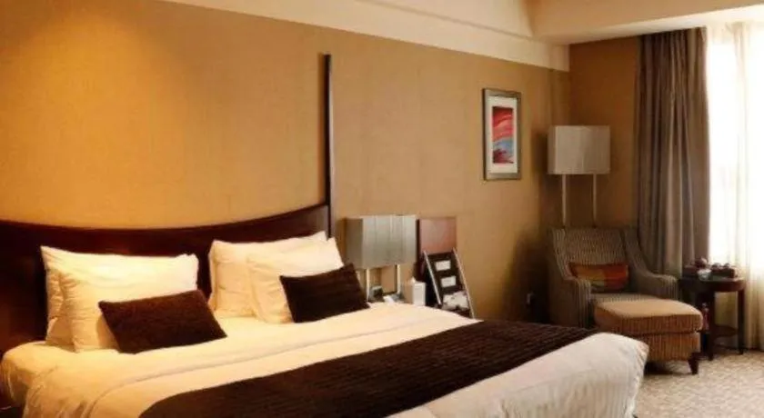 Bed in Grand New Century Hotel Binhai Tianjin