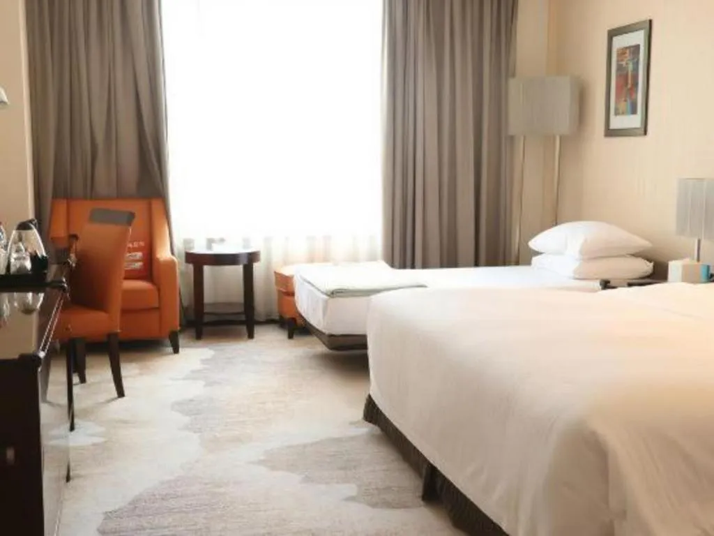 Bed in Grand New Century Hotel Binhai Tianjin