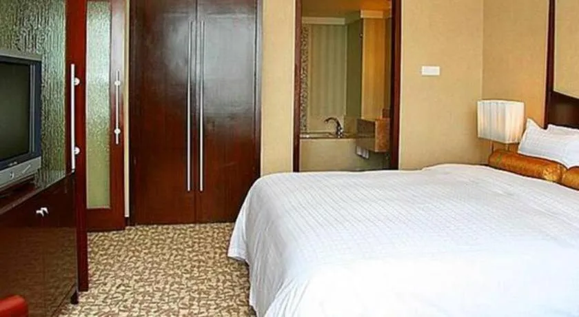 Bed in Grand New Century Hotel Binhai Tianjin